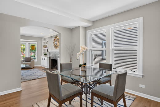 Open dining area with archway to living room in renovated Evergreen Park home