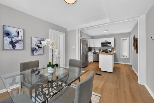 Open dining area flowing into white kitchen at 9205 S Utica Ave, Evergreen Park