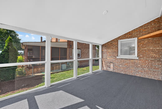 Spacious screened porch overlooking landscaped backyard at 9205 S Utica Ave, Evergreen Park