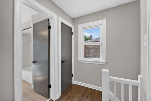 Second-floor landing with hardwood floors and sunny window, Evergreen Park home