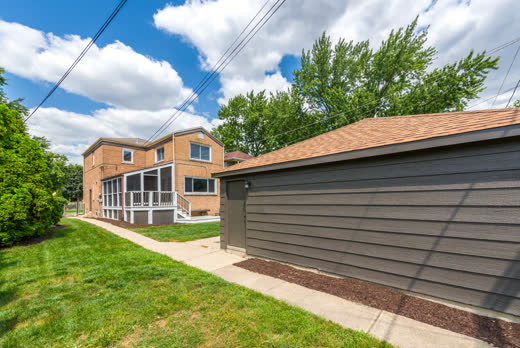 Detached garage with brand-new roof and backyard walkway at 9205 S Utica Ave, Evergreen Park