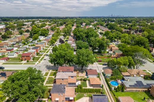 Aerial of Evergreen Park neighborhood near 9205 S Utica Ave with Chicago skyline beyond